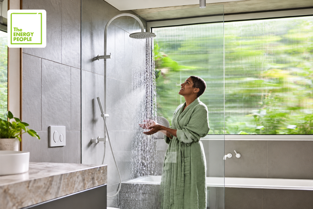 Woman checking the shower when experiencing hot water problem